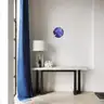 Modern round wall art with blue figure, minimalist interior decor