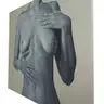Oil painting with a female torso on canvas shown from a side perspective