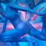 Surreal blue female nude against a luminous flower in turquoise and pink.