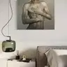 Oil painting of a male torso on the wall of a bright, modern living room