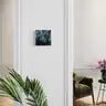 Small painting with a female nude in cool tones on the wall of a classic interior