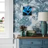Painting of a female nude in blue tones on a floral wallpaper in a rustic interior