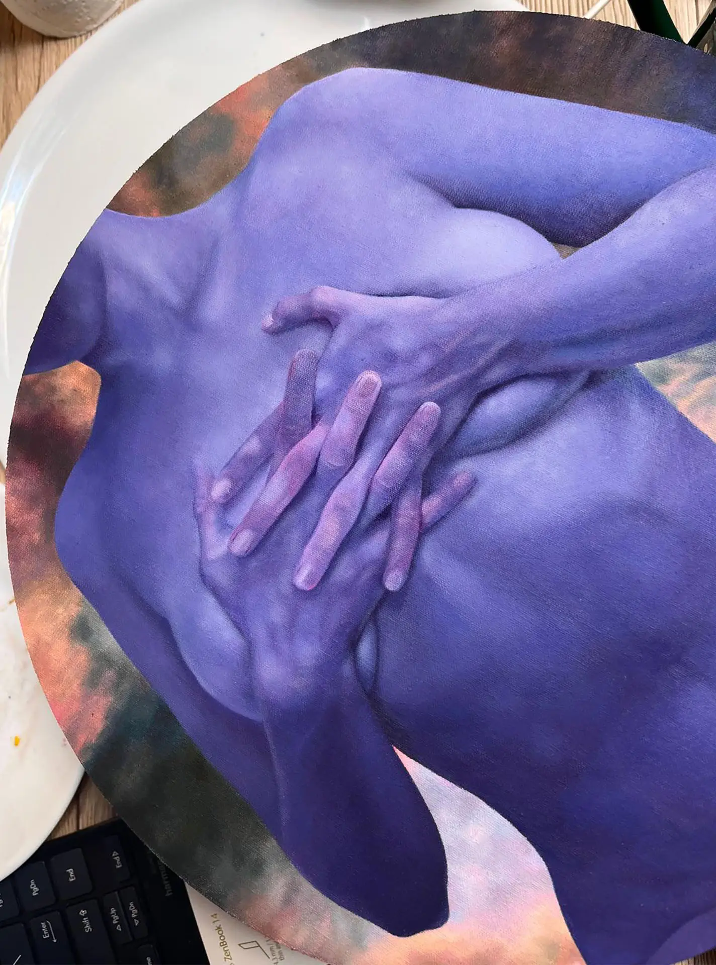 Detail of round art print with abstract female silhouette in blue and purple hues