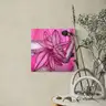 Pink painting with illustration of a female arm and leaves above an artistic table