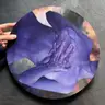 Hand-held round art print with blue female figure, contemporary art