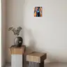 Minimalist interior with wooden tables and an abstract-themed oil painting