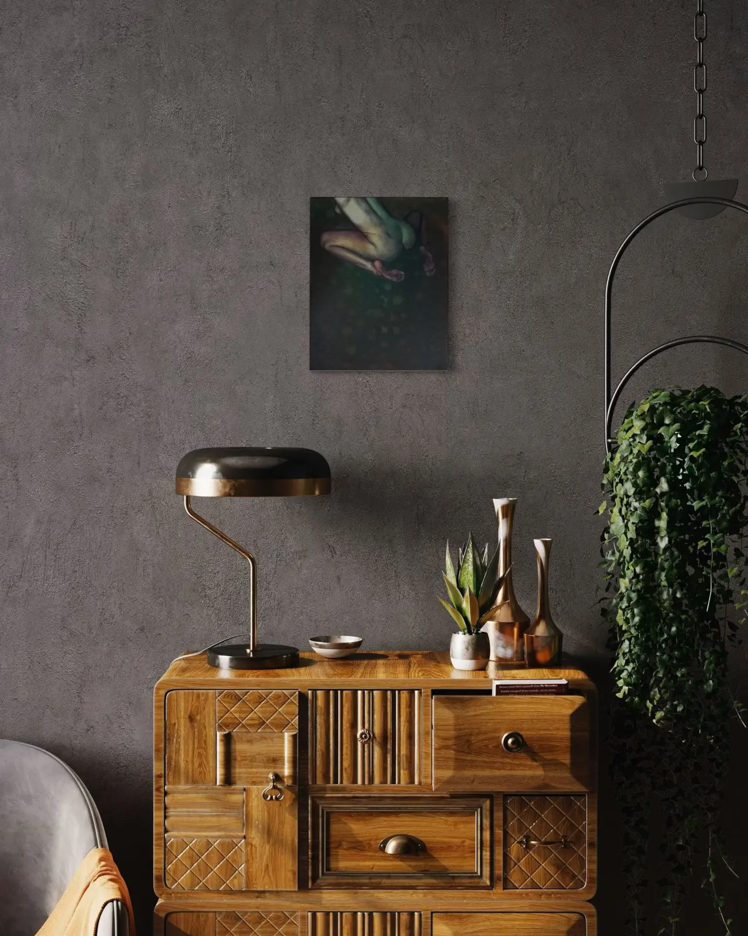Interior with a dark wall and a painting of a female nude in warm colors above a wooden sideboard