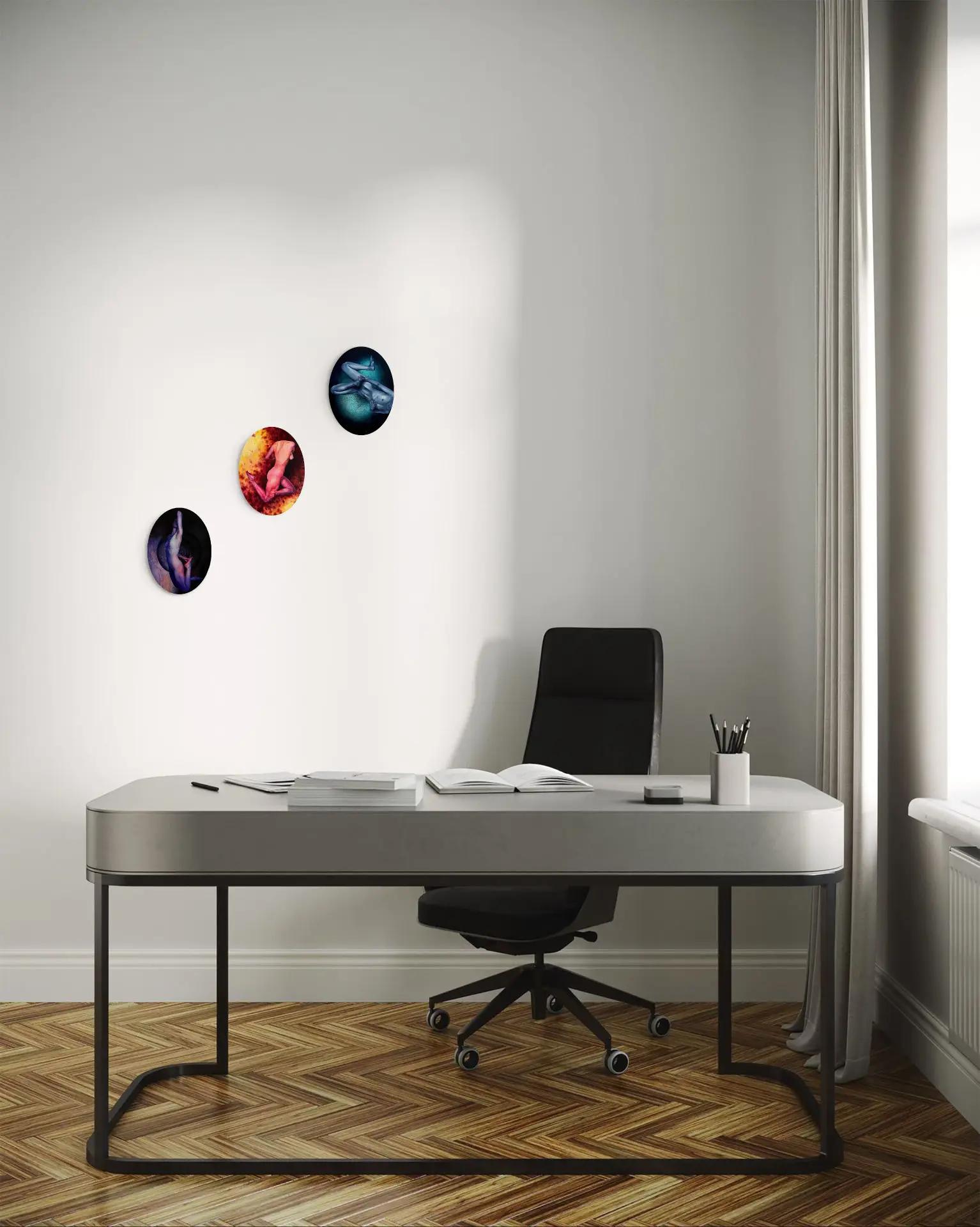 Three oval paintings of artistic nudes on a bright wall in a minimalist office