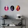 Modern interior with three oval paintings of nudes on a concrete wall