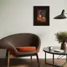 Surrealist painting with a female figure and purple leaves in a dark frame on a living room wall, next to a designer armchair and coffee table