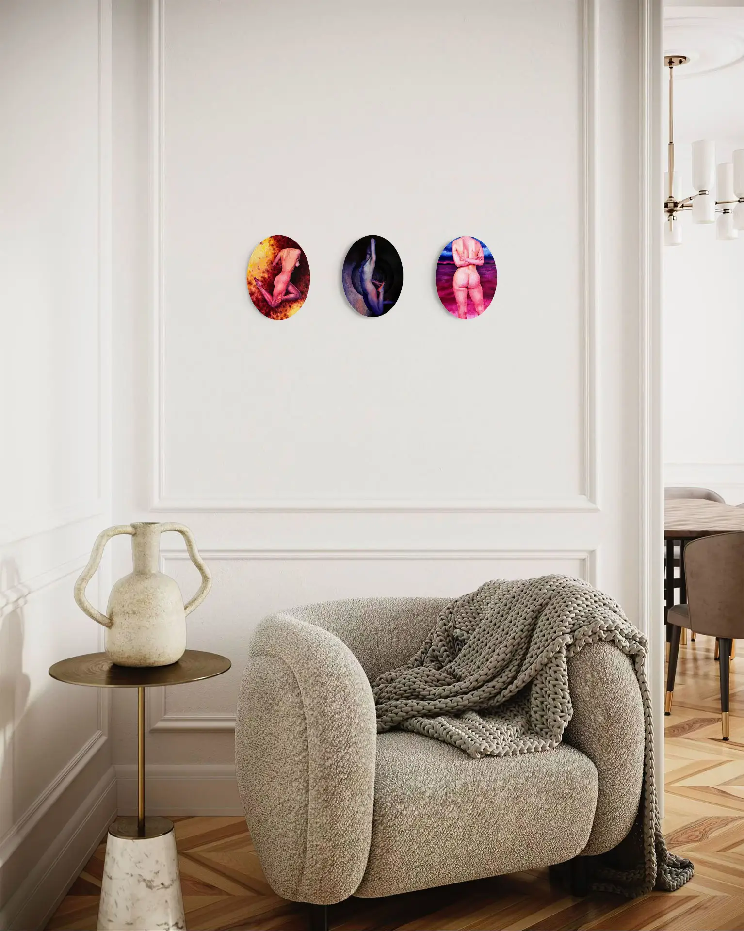 Three oval paintings with a human nude motif, hanging above a shelf in an industrial living room